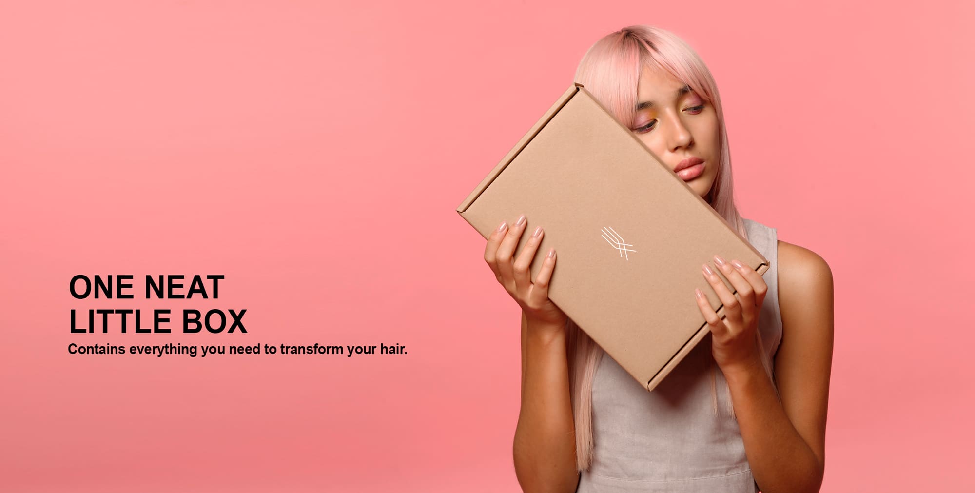 A pink-haired girl holds the Restora Treatment Set. It contains the Restora Protein Shampoo, Restora Protein Treatment and Restora Protein Conditioner.